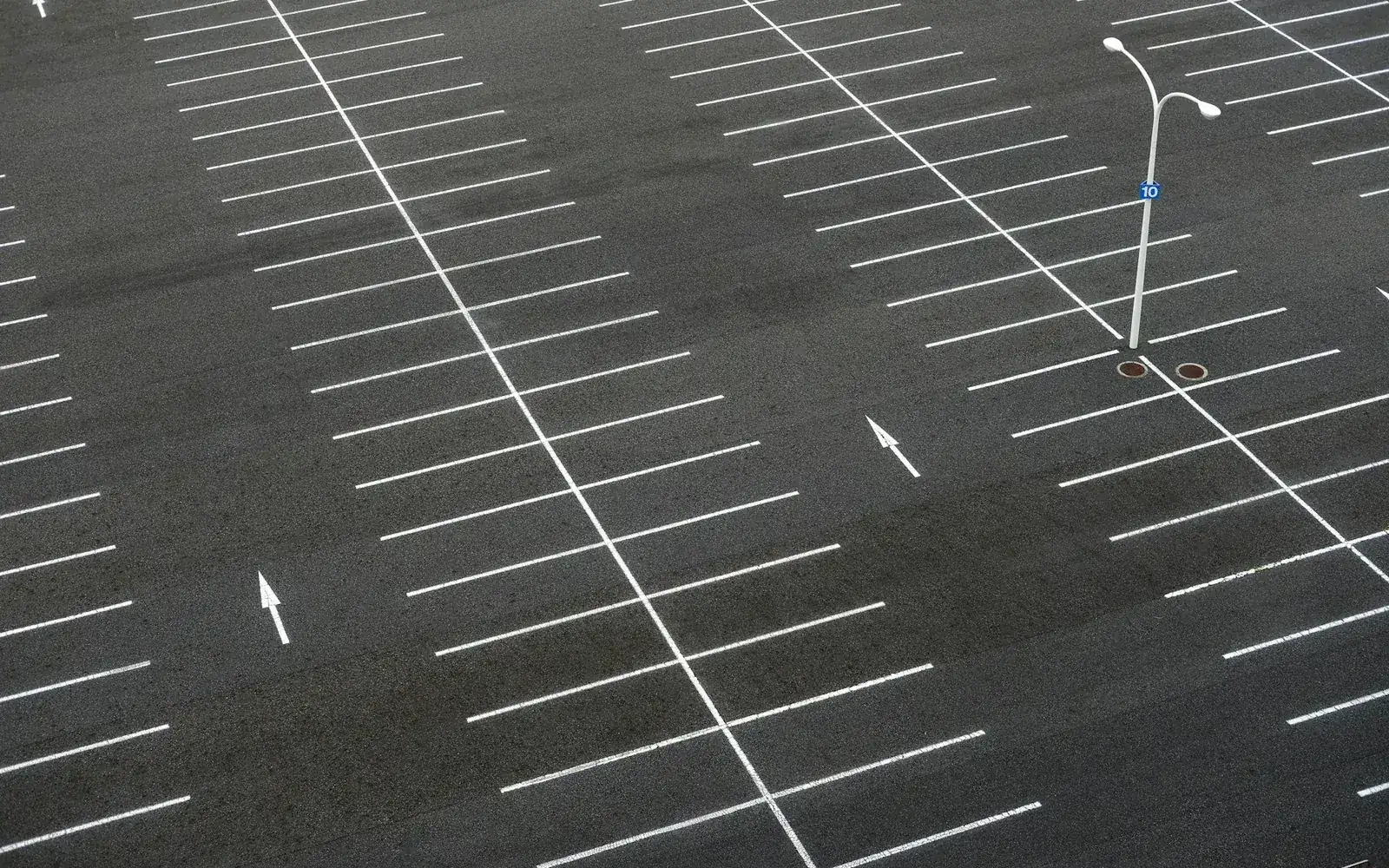 Parking markings on a paved lot; representative stock photo, not a RAVFIA project